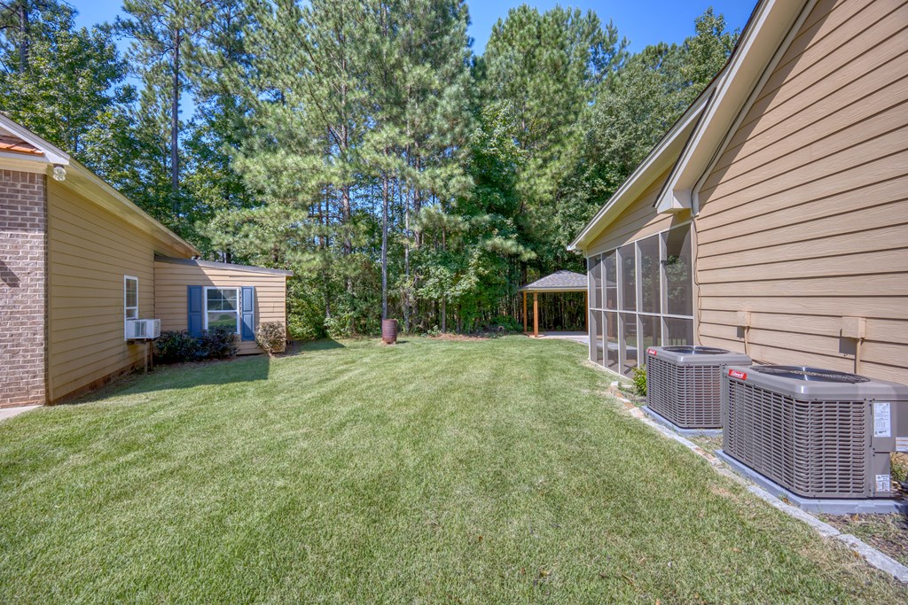 182 Oak Ridge Drive Waverly Hall, GA 31831 - Photo 8 of 52 a front view of house with yard and trees in the background