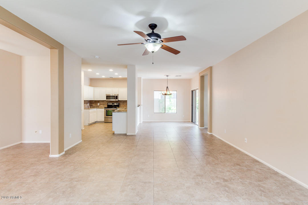 4559 West Cottontail Road Phoenix, AZ 85086 - Photo 11 of 23 a view of a big room with wooden floor and a kitchen