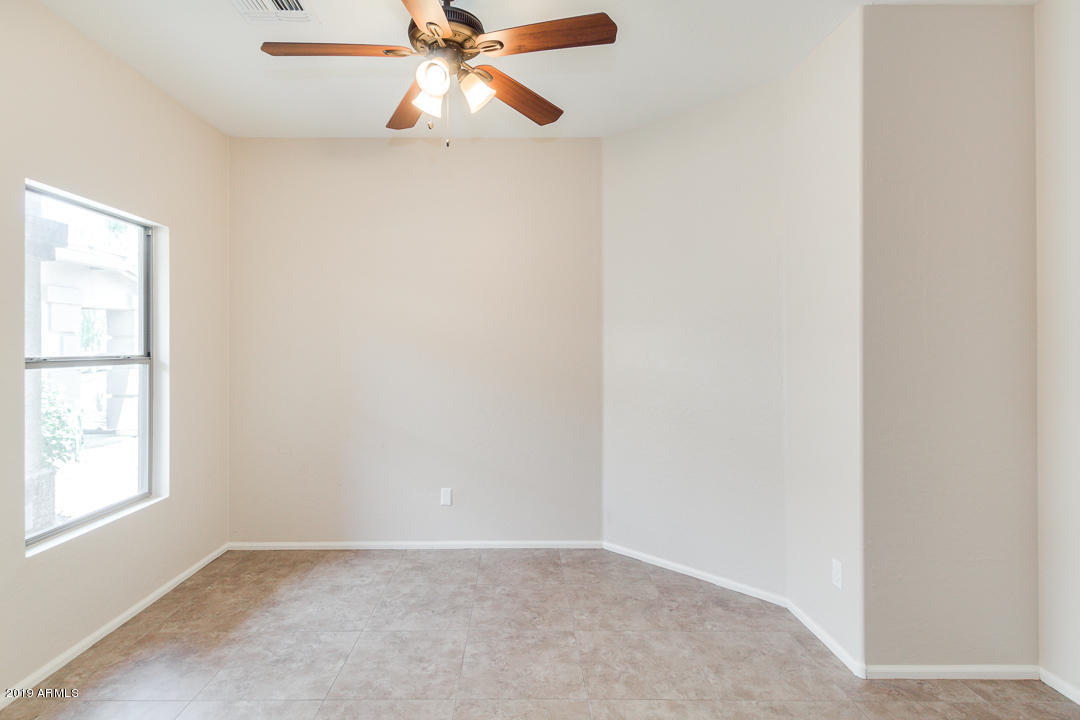 4559 West Cottontail Road Phoenix, AZ 85086 - Photo 12 of 23 an empty room with windows and fan