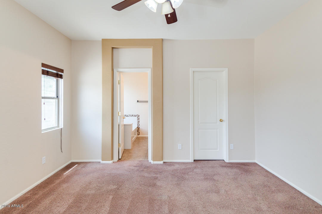 4559 West Cottontail Road Phoenix, AZ 85086 - Photo 15 of 23 an empty room with fan and windows