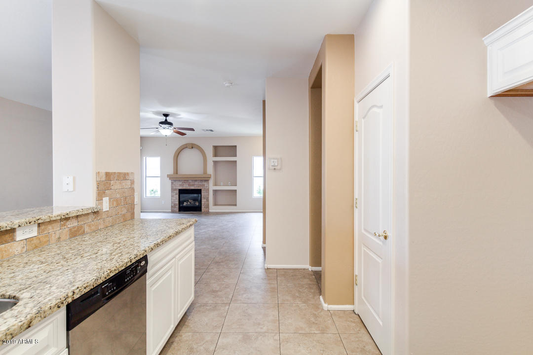 4559 West Cottontail Road Phoenix, AZ 85086 - Photo 2 of 23 a kitchen with granite countertop a sink and a stove with cabinets