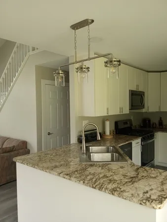 a kitchen with sink refrigerator and stove