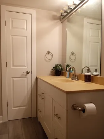 a bathroom with a double vanity sink and mirror