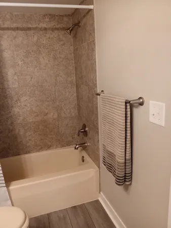 a bathroom with a bathtub and a shower