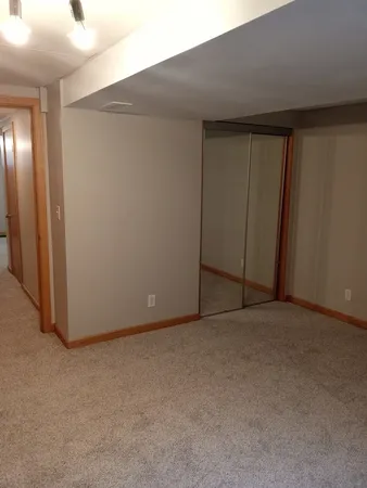 an empty room with closet area