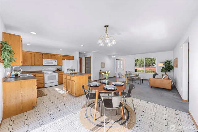 a view of a dining room with furniture and a kitchen