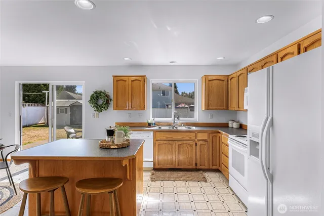 a kitchen with a stove a sink and a refrigerator