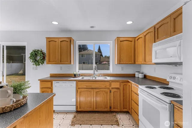 a kitchen that has a sink and a stove in it