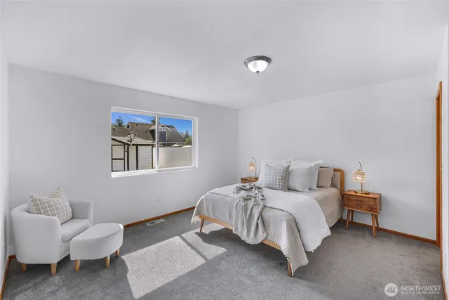 a bedroom with a bed and a couch