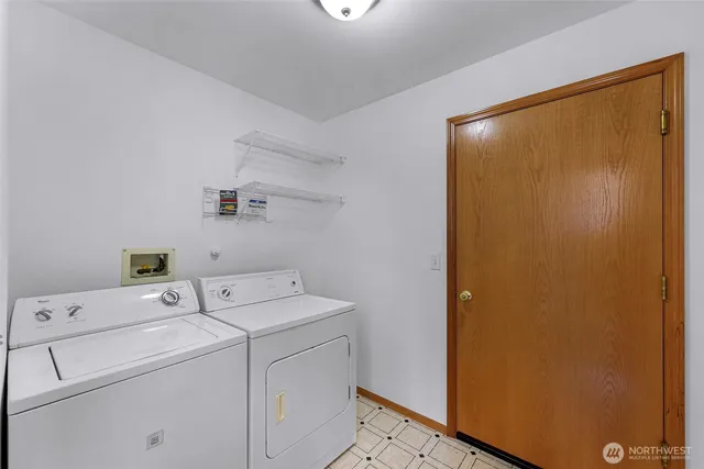 a view of storage and utility room with washer and dryer
