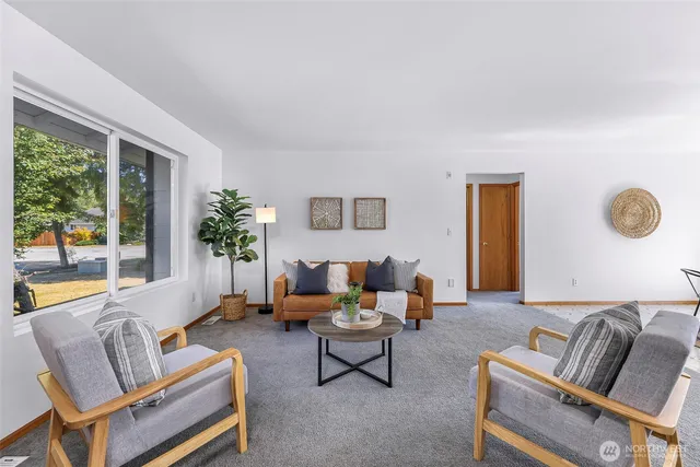 a living room with furniture and a large window