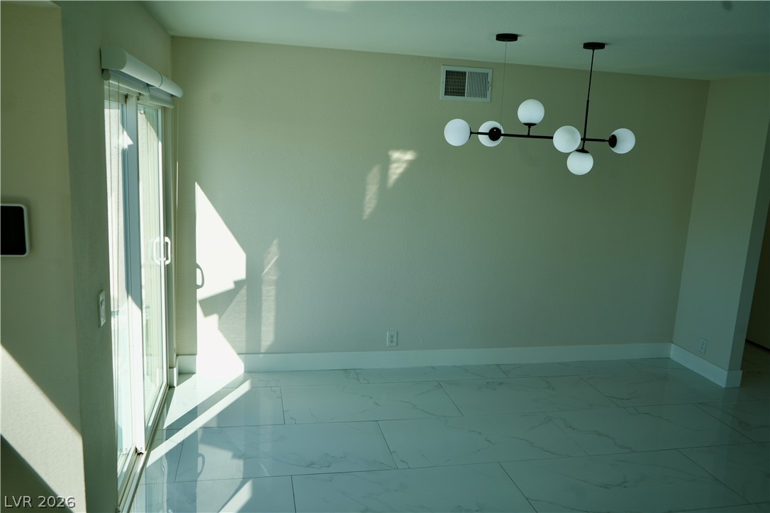 2351 Valleywood Road Henderson, NV 89014 - Photo 13 of 43 Empty room with baseboards and light marble finish floors