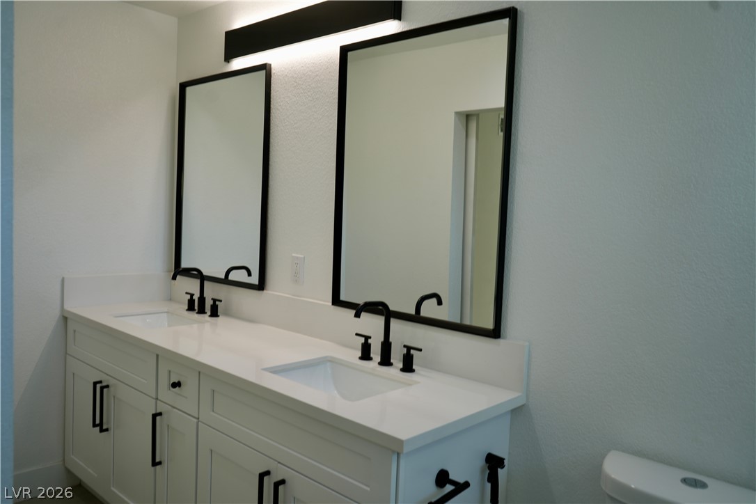 2351 Valleywood Road Henderson, NV 89014 - Photo 14 of 43 Bathroom featuring double vanity and toilet