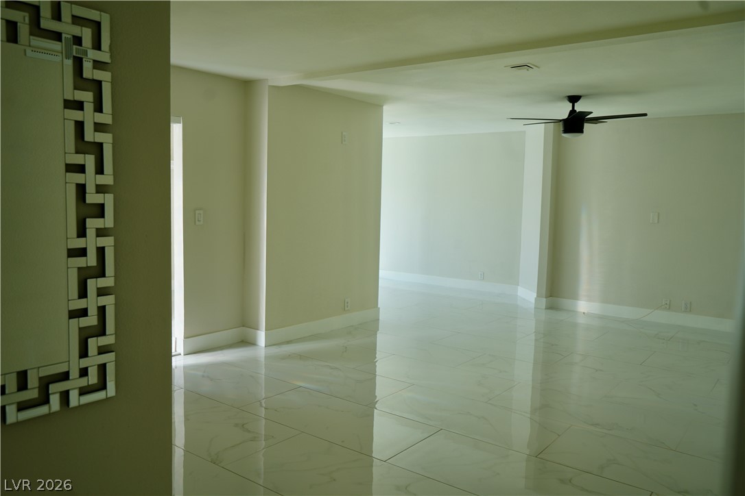 2351 Valleywood Road Henderson, NV 89014 - Photo 17 of 43 Empty room featuring light marble finish floors and a ceiling fan