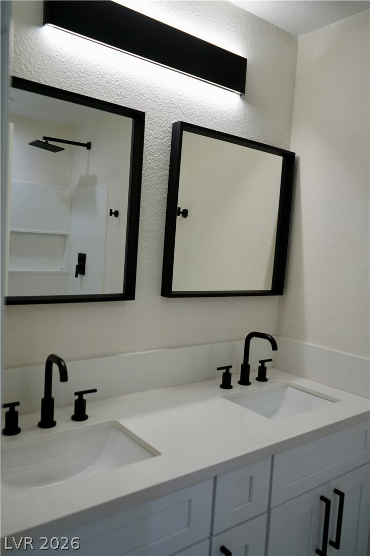 2351 Valleywood Road Henderson, NV 89014 - Photo 22 of 43 Full bath featuring double vanity and a textured wall