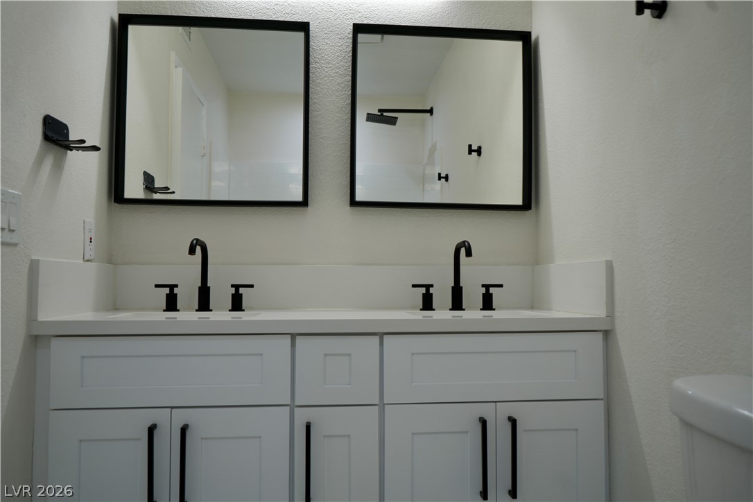 2351 Valleywood Road Henderson, NV 89014 - Photo 24 of 43 Bathroom with a textured wall and double vanity