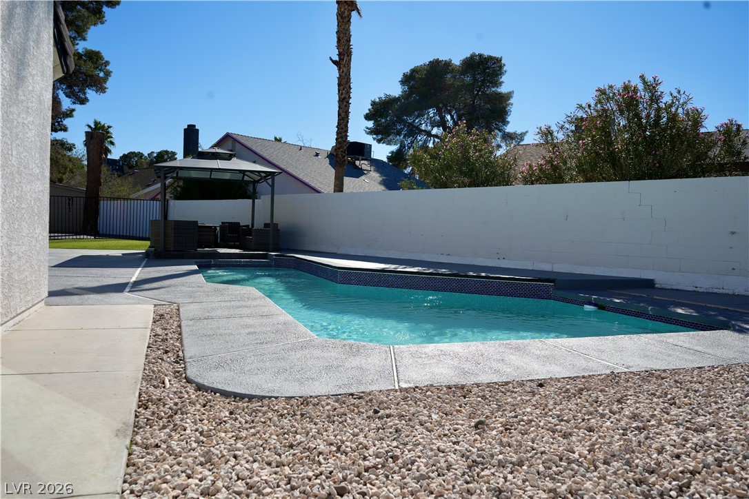 2351 Valleywood Road Henderson, NV 89014 - Photo 29 of 43 View of swimming pool featuring a gazebo, patio surround, a fenced backyard, and outdoor seating
