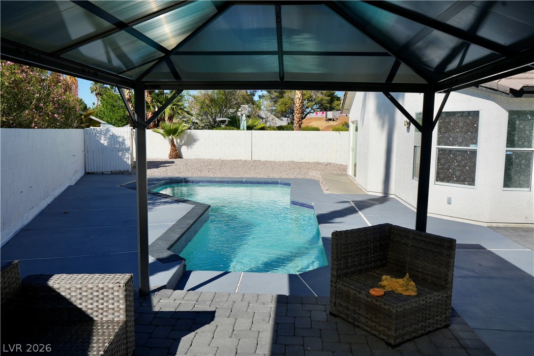 2351 Valleywood Road Henderson, NV 89014 - Photo 33 of 43 View of swimming pool with patio surround, a fenced backyard, and a gazebo