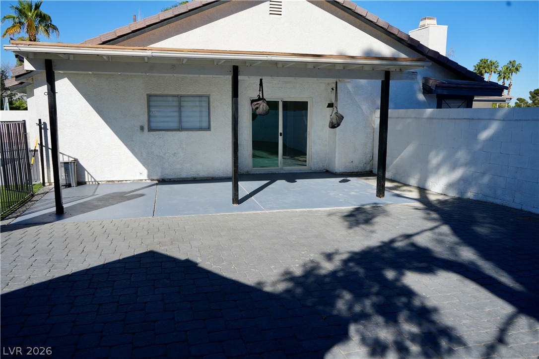 2351 Valleywood Road Henderson, NV 89014 - Photo 38 of 43 Rear view of house with a patio area, stucco siding, and a chimney