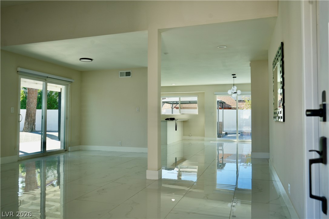 2351 Valleywood Road Henderson, NV 89014 - Photo 4 of 43 Empty room featuring plenty of natural light and light marble finish flooring