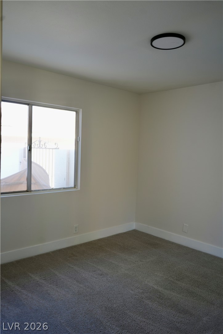 2351 Valleywood Road Henderson, NV 89014 - Photo 42 of 43 Empty room with dark colored carpet and baseboards