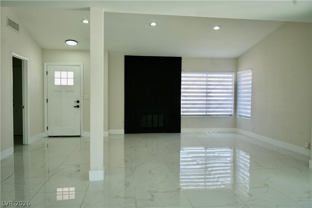 2351 Valleywood Road Henderson, NV 89014 - Photo 5 of 43 Foyer with a glass covered fireplace, light marble finish flooring, and recessed lighting