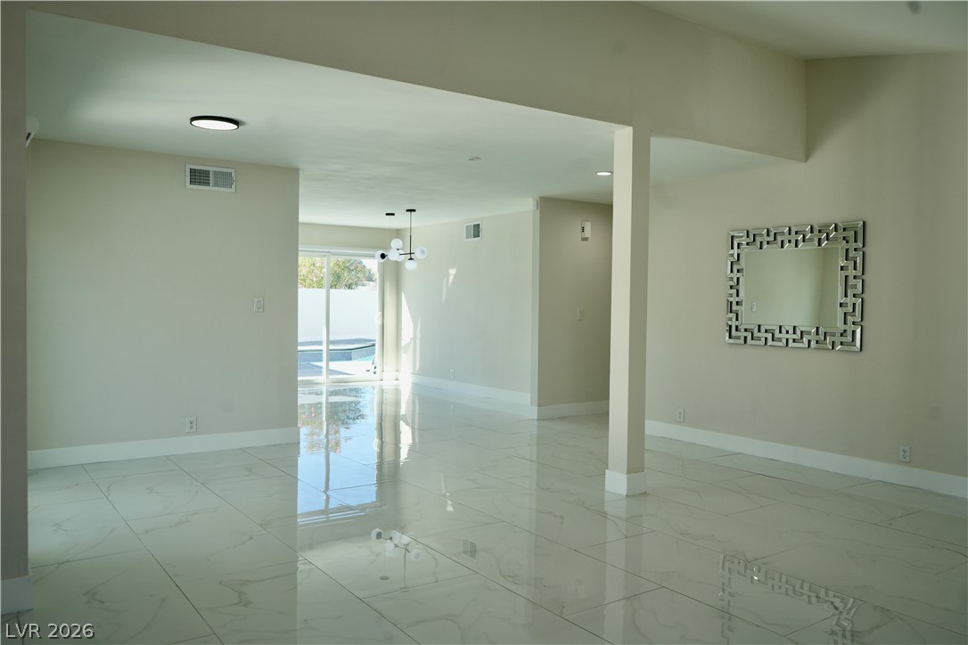 2351 Valleywood Road Henderson, NV 89014 - Photo 7 of 43 Empty room with light marble finish flooring
