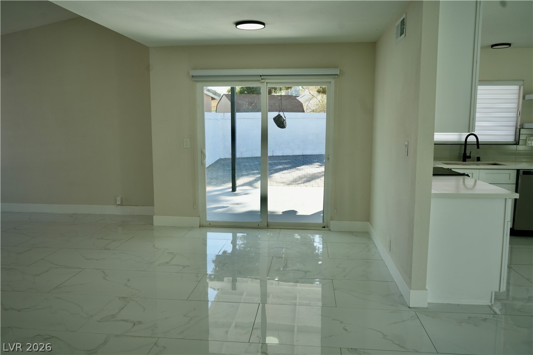 2351 Valleywood Road Henderson, NV 89014 - Photo 8 of 43 Unfurnished dining area with baseboards and light marble finish flooring