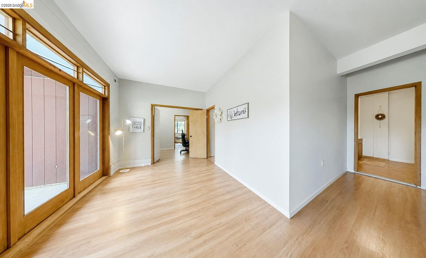 22963 Robertson Ranch Road Sonora, CA 95370 - Photo 39 of 90 Expansive room featuring wood-finish flooring, light grey walls, and a vaulted white ceiling