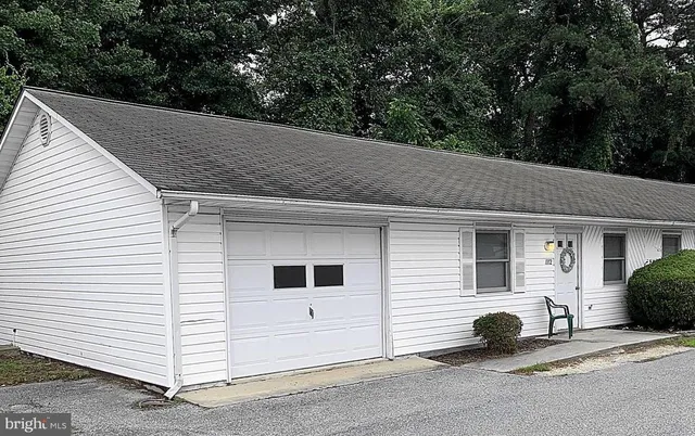 a view of a white house with a small space