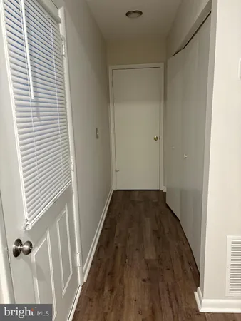 a view of a room with wooden floor and a window