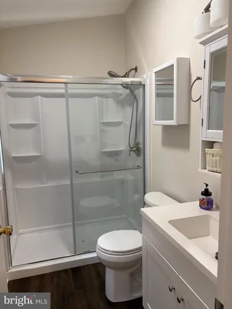 a bathroom with a sink toilet and shower