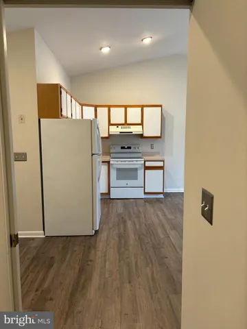 a kitchen with stainless steel appliances a refrigerator and a stove
