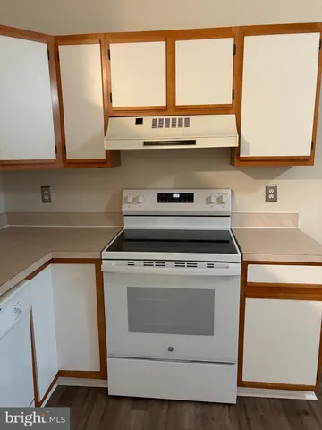 a stove top oven sitting inside of a kitchen