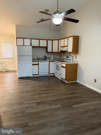 a view of kitchen with granite countertop cabinets and wooden floor