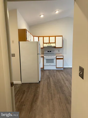 a view of a kitchen with a refrigerator and a stove