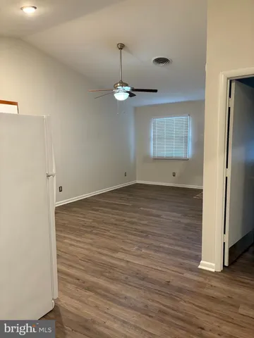 a view of room with wooden floor