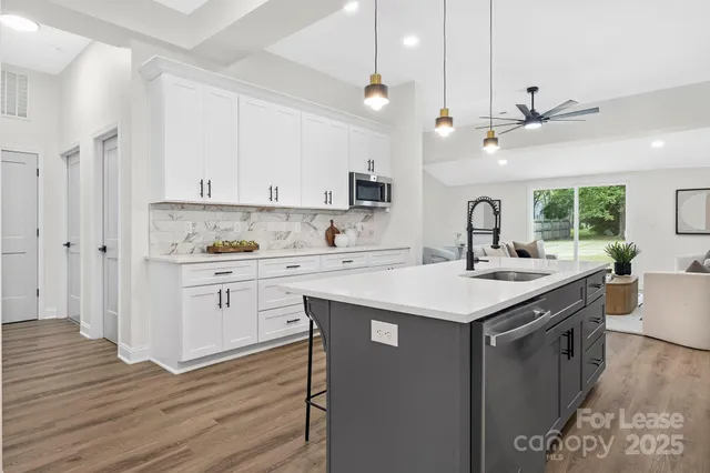 a kitchen with a sink window and cabinets