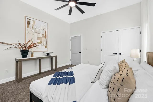 a bedroom with a large bed and a chandelier