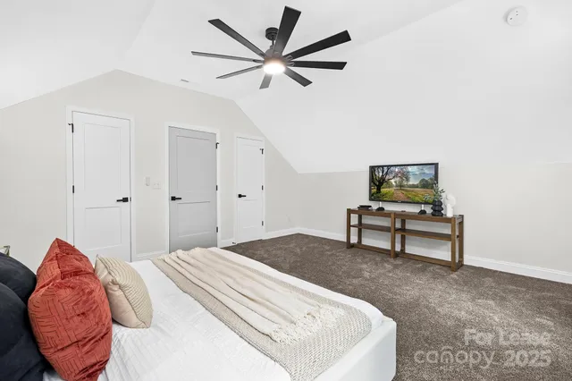 a bedroom with a bed and a potted plant