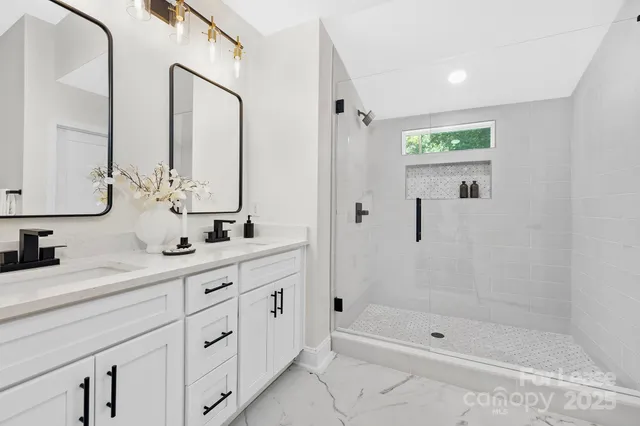 a bathroom with a shower sink and mirror