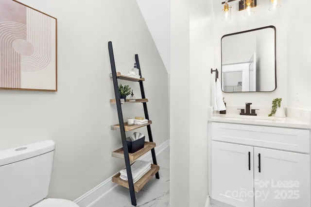 a bathroom with a toilet sink and mirror