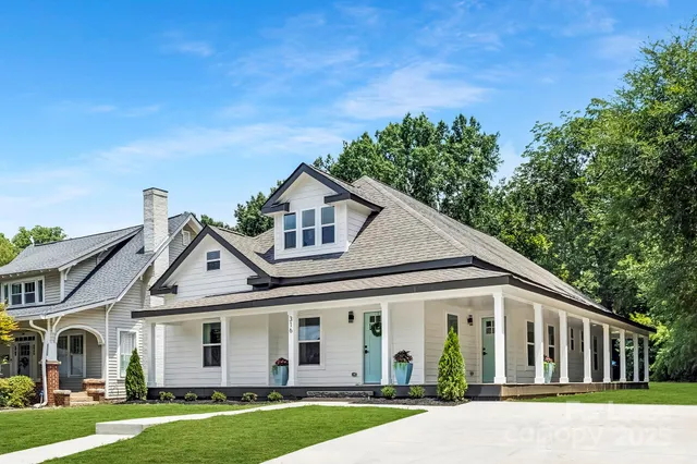 front view of a white house with a yard
