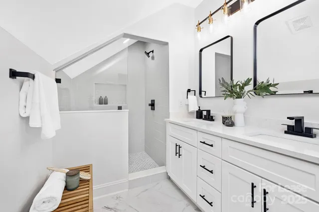a bathroom with a sink a mirror and a shower