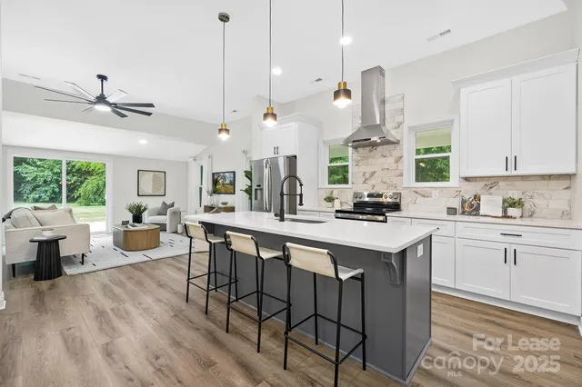 a kitchen with sink cabinets and wooden floor