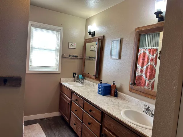 a bathroom with 2 sink and a mirror