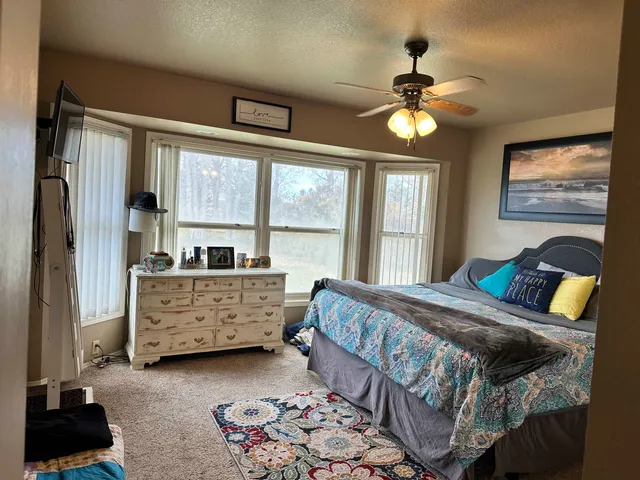 a bed room with a bed and a window