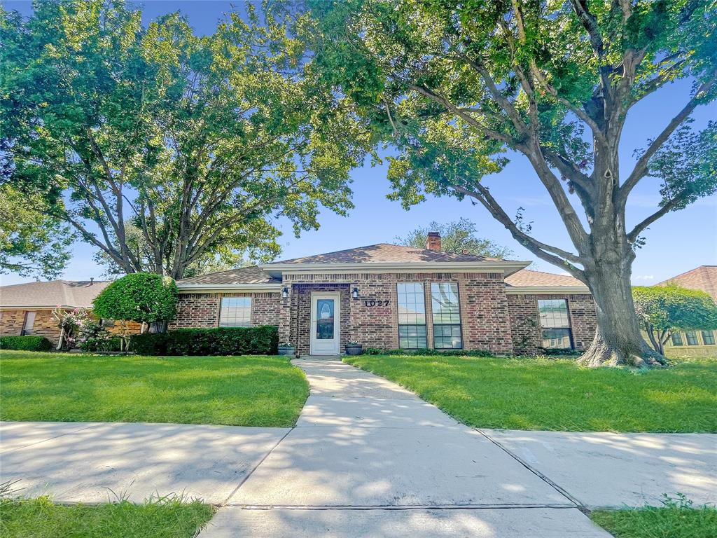 1027 Ridgeview Circle Carrollton, TX 75007 - Photo 1 of 1 a view of house in front of a big yard with large trees