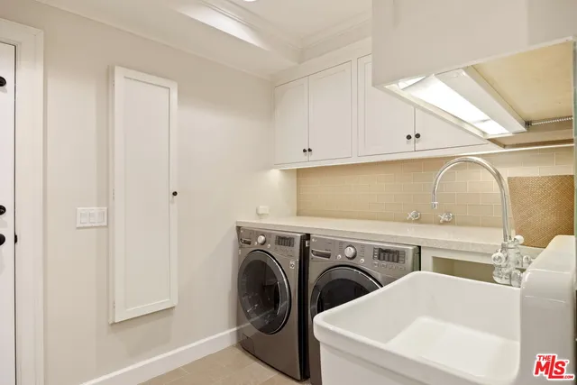 a view of an empty room with a window and a kitchen