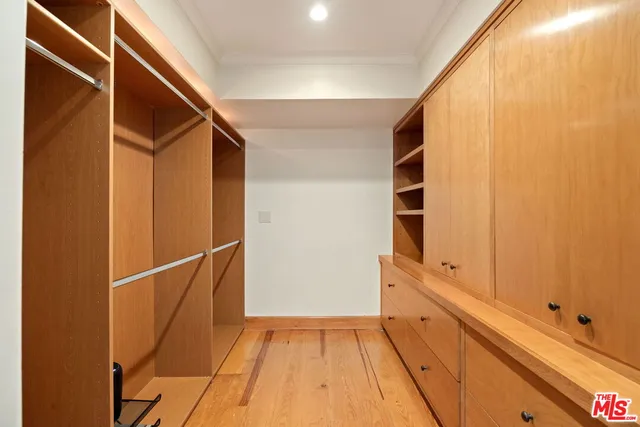 a large kitchen with stainless steel appliances granite countertop a large window and a counter top space